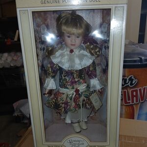 Vintage Porcelain Doll with Floral Dress and Ruffled Collar